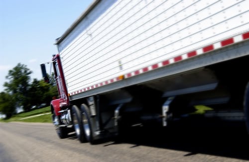 photo of an 18 wheeler big rig on the highway