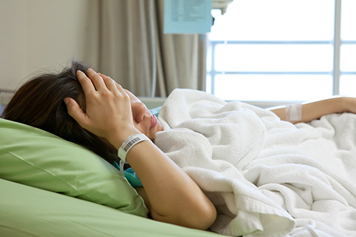 picture of a distressed woman in a hospital bed
